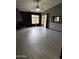 A spacious living room featuring tile floors, modern lighting, and sliding glass doors to the backyard at 815 W Kiva Ave, Mesa, AZ 85210