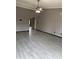 Large living room featuring neutral paint, a ceiling fan, and tile floors leading to an arched doorway at 815 W Kiva Ave, Mesa, AZ 85210