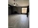 Living room with a modern fireplace, large window, and wood-look tile flooring at 815 W Kiva Ave, Mesa, AZ 85210
