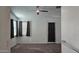 Spacious bedroom with carpet, ceiling fan, and plenty of natural light at 12461 W Midway Ave, Glendale, AZ 85307