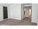 Bright bedroom with carpet flooring, an exterior door, and access to other rooms at 12461 W Midway Ave, Glendale, AZ 85307