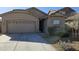 Two-story house with a two-car garage and nicely landscaped front yard at 12461 W Midway Ave, Glendale, AZ 85307