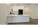 Modern kitchen with white cabinets and a breakfast bar at 12461 W Midway Ave, Glendale, AZ 85307