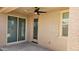 Covered patio with ceiling fan, sliding glass door, and adjacent windows at 12461 W Midway Ave, Glendale, AZ 85307