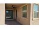 Covered patio with ceiling fan, sliding glass door, and adjacent windows at 12461 W Midway Ave, Glendale, AZ 85307