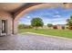 Spacious backyard with covered patio and lush lawn at 18654 W Solano Dr, Litchfield Park, AZ 85340
