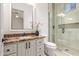Bathroom with marble vanity, walk-in shower, and toilet at 18654 W Solano Dr, Litchfield Park, AZ 85340