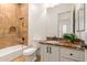 Clean bathroom with tiled shower and marble vanity at 18654 W Solano Dr, Litchfield Park, AZ 85340