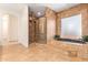 Spa-like bathroom with soaking tub, walk-in shower, and tile flooring at 18654 W Solano Dr, Litchfield Park, AZ 85340