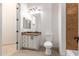Bathroom with toilet, vanity, and brown tile at 18654 W Solano Dr, Litchfield Park, AZ 85340
