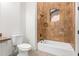 Bathroom with shower/tub combo and brown tile at 18654 W Solano Dr, Litchfield Park, AZ 85340