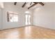 Bright bedroom with French doors, large windows, and ceiling fan at 18654 W Solano Dr, Litchfield Park, AZ 85340