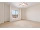 Bedroom with window seat, ceiling fan, and carpet flooring at 18654 W Solano Dr, Litchfield Park, AZ 85340
