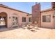 Inviting courtyard with a stone fireplace and seating area at 18654 W Solano Dr, Litchfield Park, AZ 85340