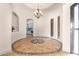 Elegant dining room with a circular inlaid tile floor and chandelier at 18654 W Solano Dr, Litchfield Park, AZ 85340