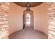 Elegant entryway with arched walkways and stone details at 18654 W Solano Dr, Litchfield Park, AZ 85340