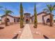 Home exterior with walkway and lush landscaping at 18654 W Solano Dr, Litchfield Park, AZ 85340