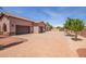 Front exterior of a beautiful home with a large driveway and landscaping at 18654 W Solano Dr, Litchfield Park, AZ 85340