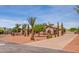 Home with palm trees, landscaping, and a paved driveway at 18654 W Solano Dr, Litchfield Park, AZ 85340
