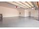 Garage with automatic door opener and epoxy flooring at 18654 W Solano Dr, Litchfield Park, AZ 85340