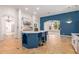 Modern kitchen with blue island, granite counters and stainless steel appliances at 18654 W Solano Dr, Litchfield Park, AZ 85340