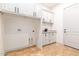 Laundry room with white cabinets and tile flooring at 18654 W Solano Dr, Litchfield Park, AZ 85340