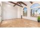 Living area with wood beams, arched windows, and tile flooring at 18654 W Solano Dr, Litchfield Park, AZ 85340