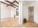 Spacious living room with high ceilings, wood beams, and tile floors at 18654 W Solano Dr, Litchfield Park, AZ 85340