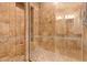 Large walk-in shower with tile surround and built-in seat at 18654 W Solano Dr, Litchfield Park, AZ 85340
