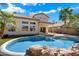Backyard featuring a sparkling pool, patio area and manicured lawn with lush palms; ideal for outdoor entertaining at 19406 N 31St Way, Phoenix, AZ 85050