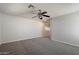 A cozy bedroom featuring neutral walls, plush gray carpet, and a ceiling fan for added comfort at 19406 N 31St Way, Phoenix, AZ 85050