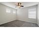 A bright bedroom featuring carpeted floors, crisp white walls, and natural light from dual windows at 19406 N 31St Way, Phoenix, AZ 85050