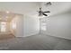 Bright bedroom featuring neutral carpet, a ceiling fan, and natural light from the window at 19406 N 31St Way, Phoenix, AZ 85050