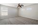 Spacious bedroom featuring neutral carpet, a ceiling fan, and natural light from three windows at 19406 N 31St Way, Phoenix, AZ 85050