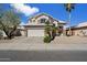 Charming two-story home featuring desert landscaping, a two-car garage, and a beige stucco exterior at 19406 N 31St Way, Phoenix, AZ 85050