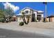 Charming two-story home featuring desert landscaping, a two-car garage, and a beige stucco exterior at 19406 N 31St Way, Phoenix, AZ 85050