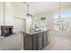 Modern kitchen island overlooking living room featuring granite countertops and stainless steel dishwasher at 19406 N 31St Way, Phoenix, AZ 85050