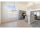 Open kitchen with a dining area featuring grey cabinetry, granite countertops, and tile floors at 19406 N 31St Way, Phoenix, AZ 85050