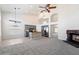 Open-concept living area features gray cabinetry, a tile backsplash, stainless steel appliances, and a cozy fireplace at 19406 N 31St Way, Phoenix, AZ 85050