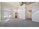 Bright and airy living room with a wooden front door, neutral carpet, and large windows at 19406 N 31St Way, Phoenix, AZ 85050