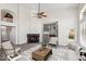 Inviting living room with stone fireplace, built-in bookshelves, and comfortable seating at 19406 N 31St Way, Phoenix, AZ 85050