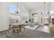 Bright living room with high ceilings, large windows, and elegant chandelier lighting at 19406 N 31St Way, Phoenix, AZ 85050