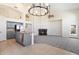 Open-concept living area boasts gray cabinetry, granite counters, fireplace, and plenty of natural light at 19406 N 31St Way, Phoenix, AZ 85050