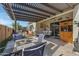Outdoor patio with pergola, seating area, and dining table at 369 W Glacier Bay Dr, San Tan Valley, AZ 85140