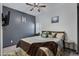 Comfortable guest bedroom with ceiling fan and wood floors at 369 W Glacier Bay Dr, San Tan Valley, AZ 85140