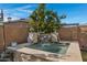 Relaxing hot tub with a stone finish and waterfall feature at 369 W Glacier Bay Dr, San Tan Valley, AZ 85140