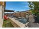 Stone hot tub with waterfall feature in the backyard at 369 W Glacier Bay Dr, San Tan Valley, AZ 85140