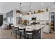 Eat-in kitchen with granite island, white cabinets, and stainless steel appliances at 369 W Glacier Bay Dr, San Tan Valley, AZ 85140