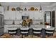Modern kitchen island with granite countertops and seating for four at 369 W Glacier Bay Dr, San Tan Valley, AZ 85140