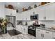Kitchen features granite countertops, white cabinets, and stainless steel appliances at 369 W Glacier Bay Dr, San Tan Valley, AZ 85140
